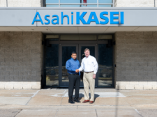 Phani Nagaraj (left) and Todd Glogovsky (right) standing in front of Asahi Kasei Plastics North America in Fowlerville, Michigan